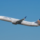 United Airlines plane takes off into clear blue sky